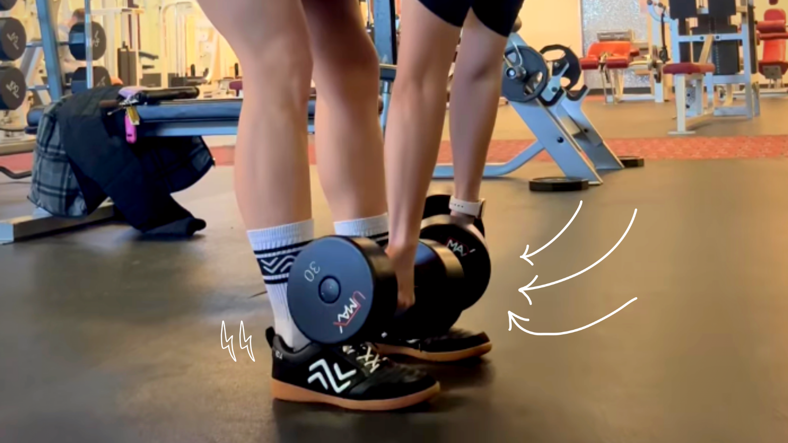 Female athlete bending at the hips holding a dumbbell weight doing an RDL exercise wearing IDA Spirit indoor futsal shoes for women.
